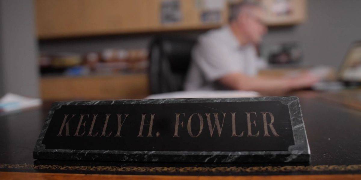 The name tag on Kelly Fowler's desk in his law firm office